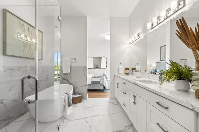 a spacious bathroom with a double vanity sink and a mirror