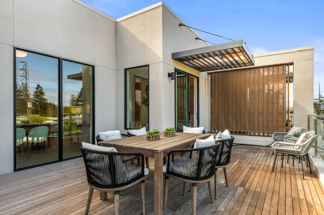 a view of a patio with table and chairs