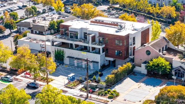 a front view of a multi story residential apartment building with yard