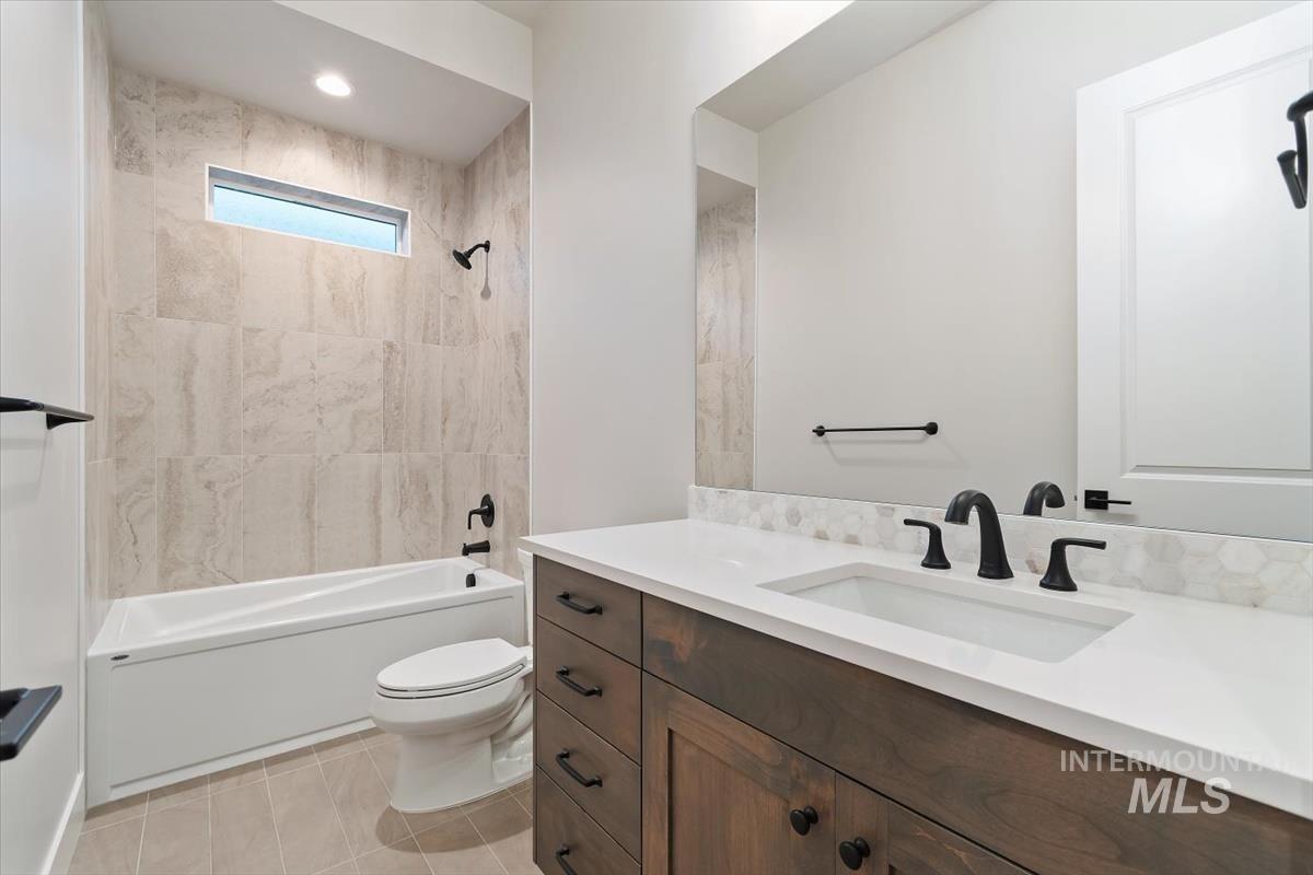 2147 East Blakehurst Avenue Kuna, ID 83634 - Photo 34 of 43 Bathroom with shower / bath combination, vanity, and light tile patterned flooring