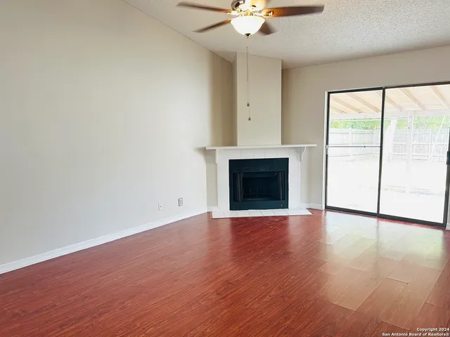 wooden floor fireplace and natural light in room