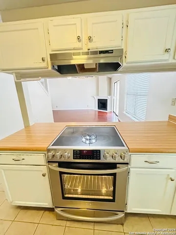 a stove top oven sitting inside of a kitchen