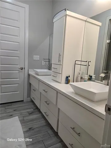a bathroom with a double vanity sink and a mirror