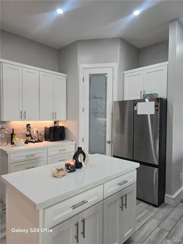 a kitchen with a refrigerator sink and stove
