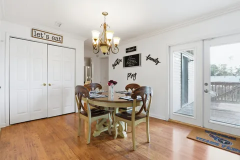 a view of a dining room with furniture and chandelier
