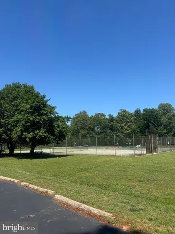 a view of a swimming pool with lawn chairs under an umbrella