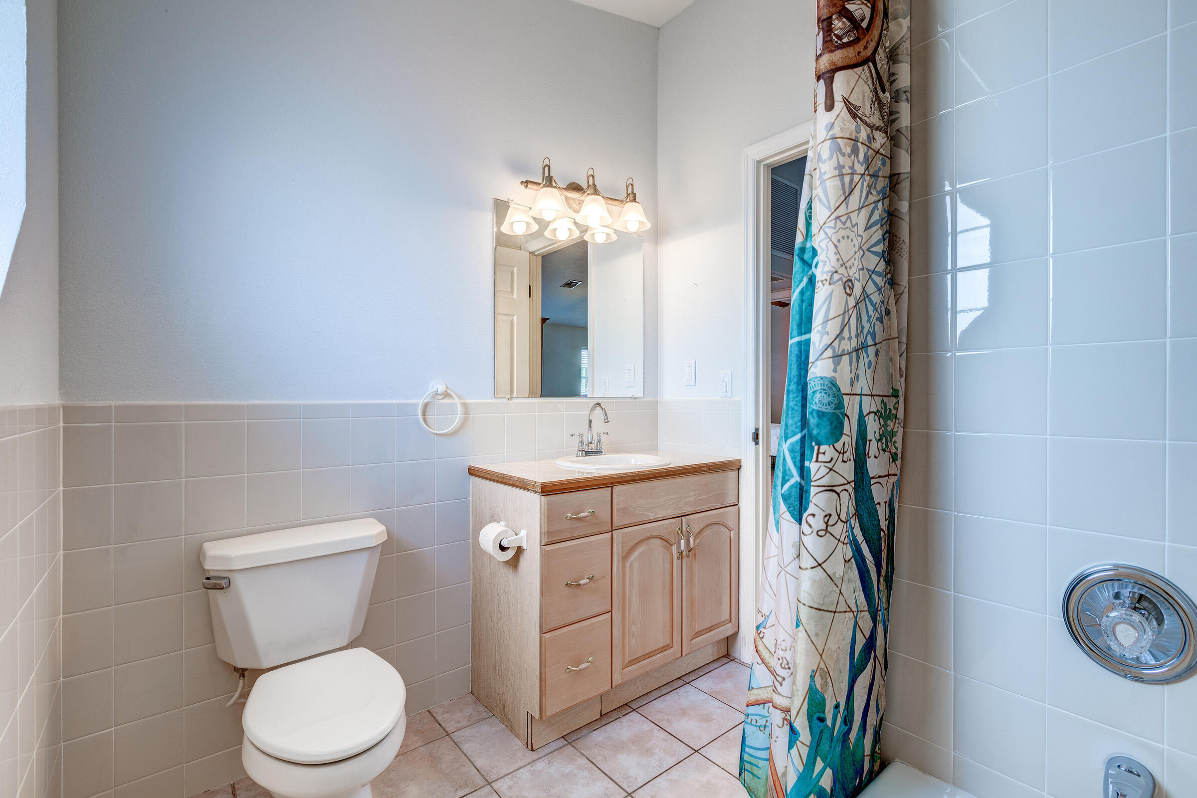 22808 Privateer Drive Cudjoe, FL 33042 - Photo 12 of 28 a bathroom with a toilet a sink and a mirror