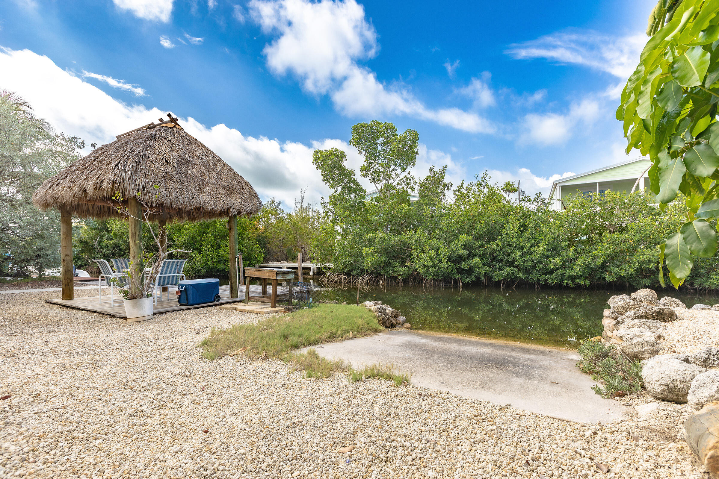 22808 Privateer Drive Cudjoe, FL 33042 - Photo 19 of 28 a view of a lake with couches and wooden fence