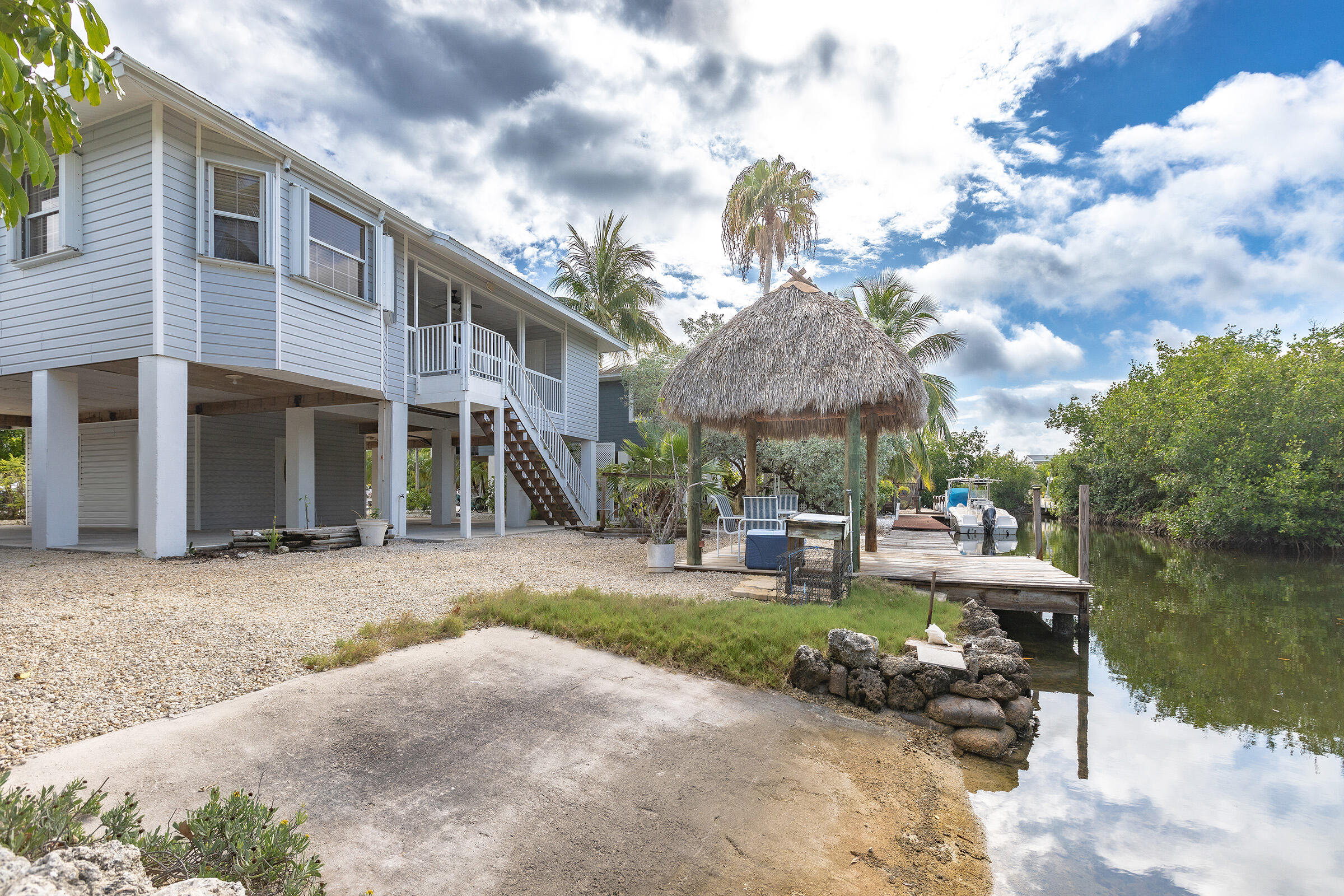 22808 Privateer Drive Cudjoe, FL 33042 - Photo 20 of 28 a view of a building with sitting area and garden