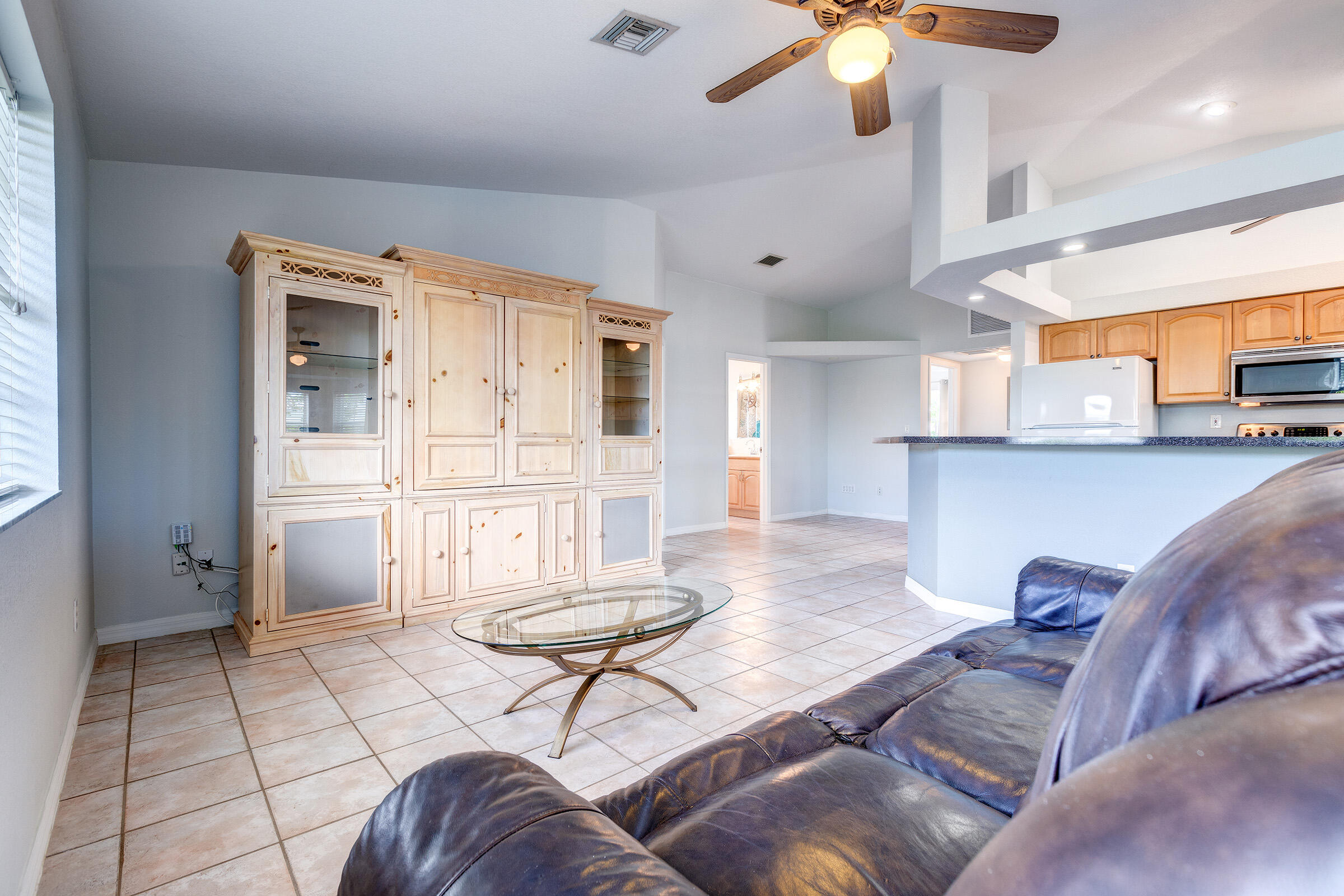 22808 Privateer Drive Cudjoe, FL 33042 - Photo 4 of 28 a living room with furniture and a chandelier