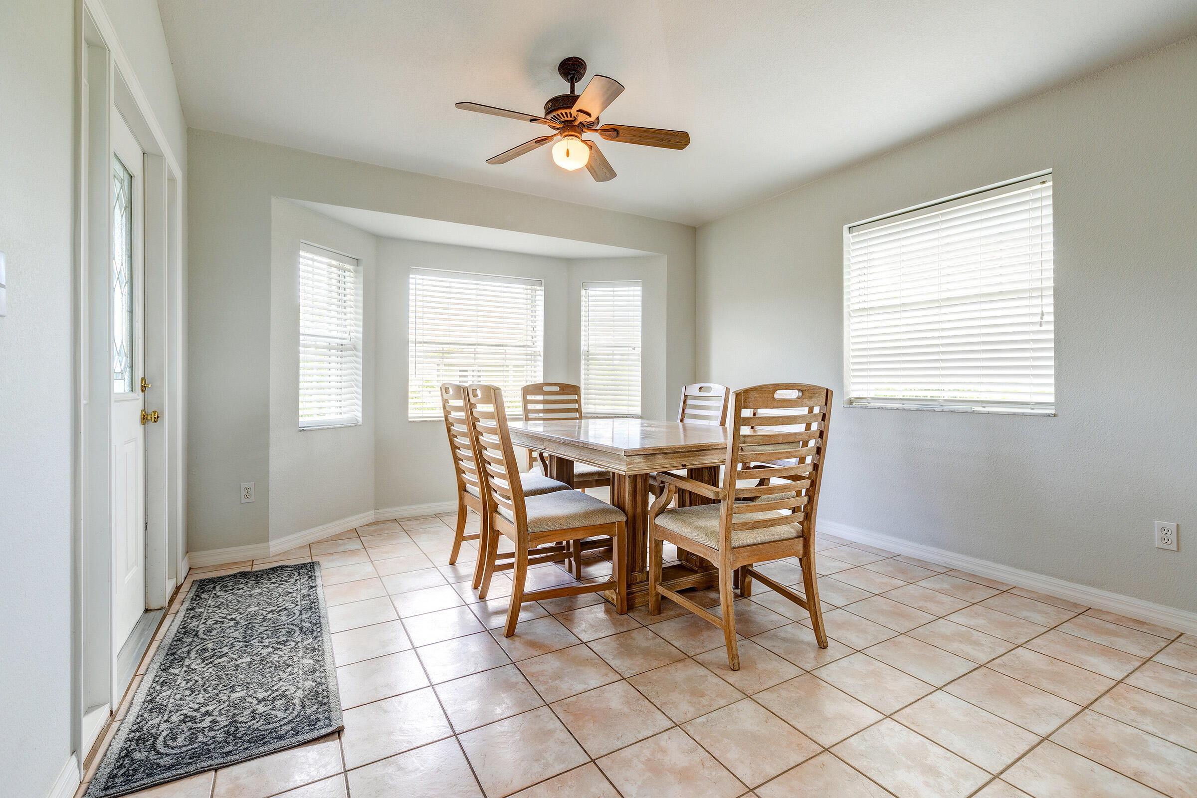 22808 Privateer Drive Cudjoe, FL 33042 - Photo 6 of 28 a dining room with furniture a chandelier and a window