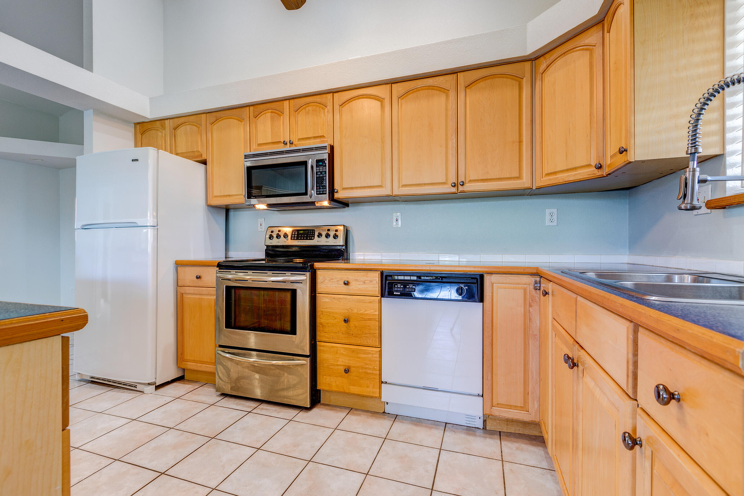 22808 Privateer Drive Cudjoe, FL 33042 - Photo 7 of 28 a kitchen with stainless steel appliances granite countertop a stove a sink and a microwave