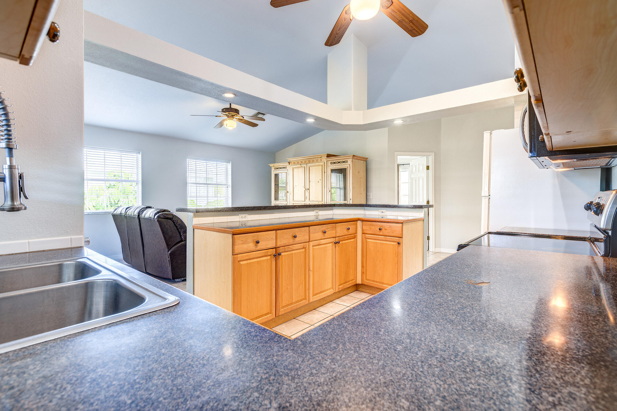 22808 Privateer Drive Cudjoe, FL 33042 - Photo 8 of 28 a kitchen with stainless steel appliances granite countertop a sink a stove cabinets and wooden floor
