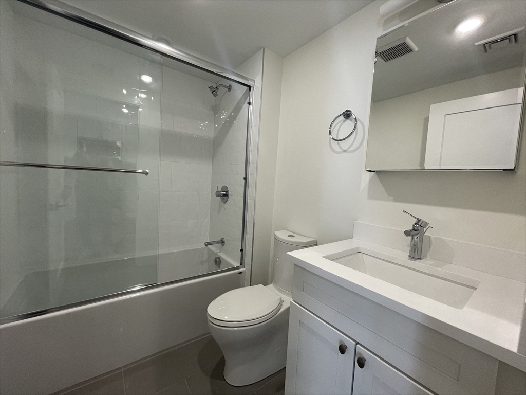 49 Alpine Street, Unit 2 Boston, MA 02119 - Photo 15 of 18 a bathroom with a sink a toilet and shower