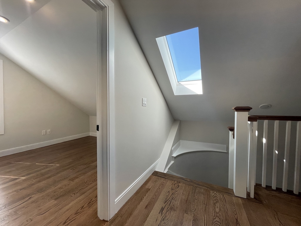 49 Alpine Street, Unit 2 Boston, MA 02119 - Photo 5 of 18 wooden floor in an empty room with a gallery