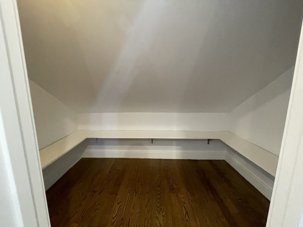 49 Alpine Street, Unit 2 Boston, MA 02119 - Photo 7 of 18 a view of walk in closet with wooden floor