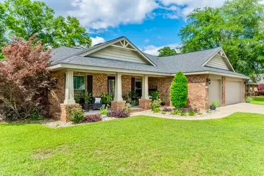 a front view of house with yard and outdoor seating