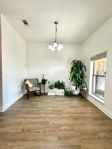 a view of a livingroom with a furniture and floor to ceiling window
