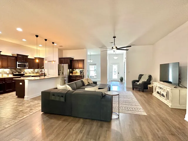 a kitchen with stainless steel appliances kitchen island granite countertop a sink stove and refrigerator