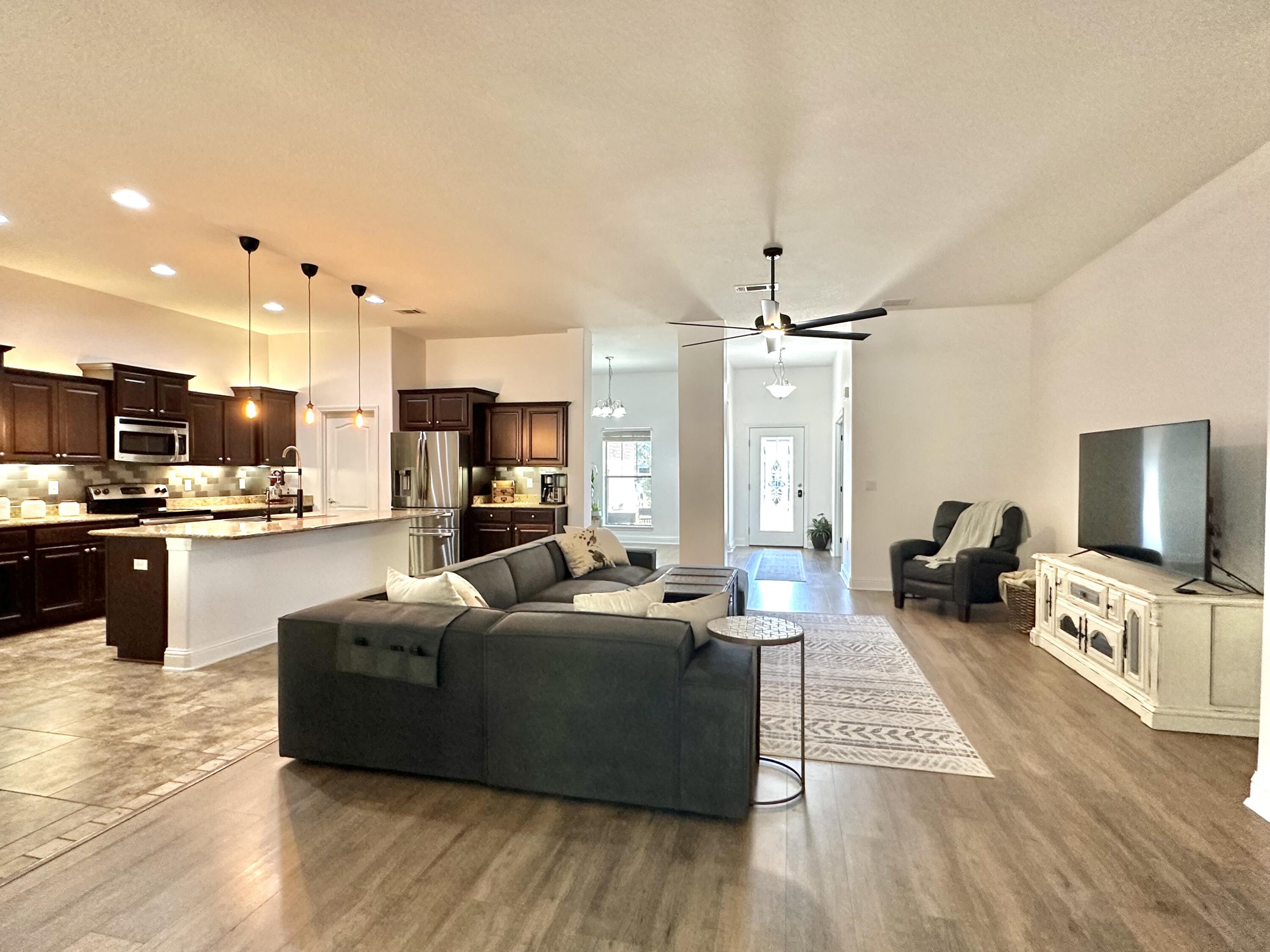 5930 Wind Trace Road Crestview, FL 32536 - Photo 13 of 68 a living room with furniture and a flat screen tv