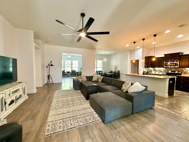 a kitchen with granite countertop stainless steel appliances a stove sink and cabinets