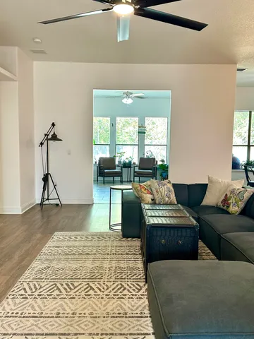 a kitchen with stainless steel appliances granite countertop a sink a stove and a wooden floor