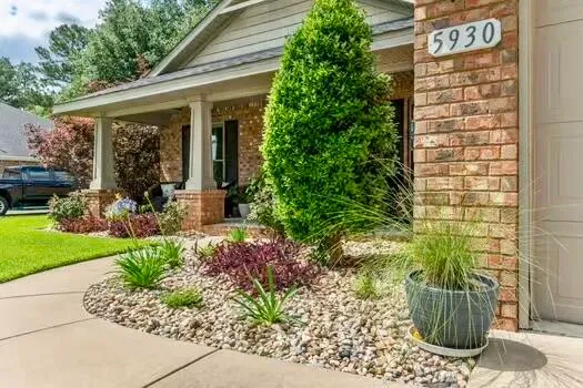 a front view of a house with garden