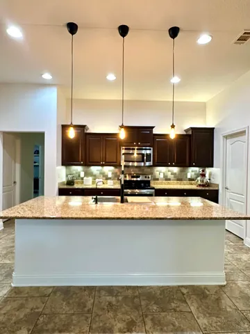 a bedroom with a bed and dresser with mirror