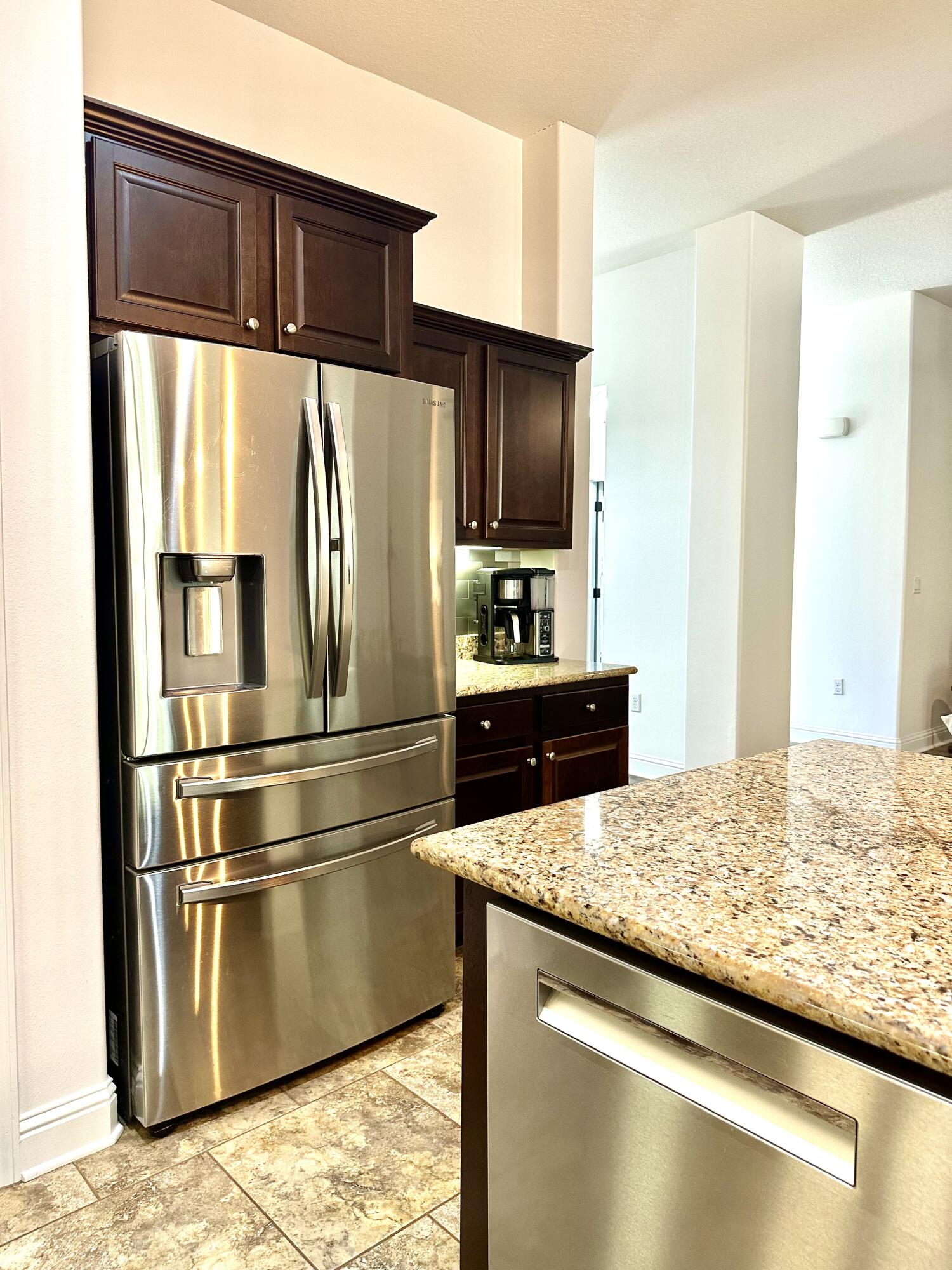 5930 Wind Trace Road Crestview, FL 32536 - Photo 22 of 68 a kitchen with granite countertop a refrigerator a stove and a sink