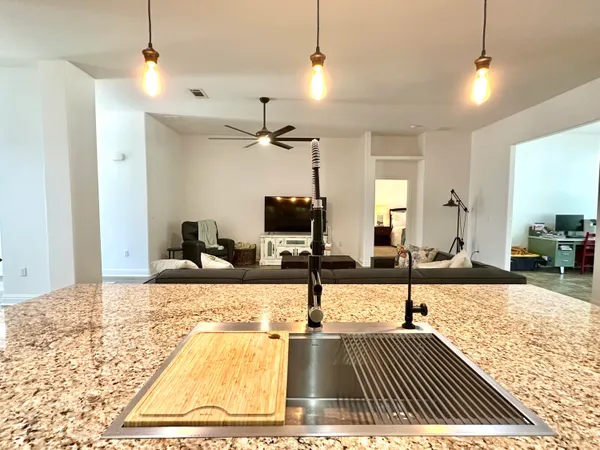 a spacious bathroom with a granite countertop sink a mirror and a shower