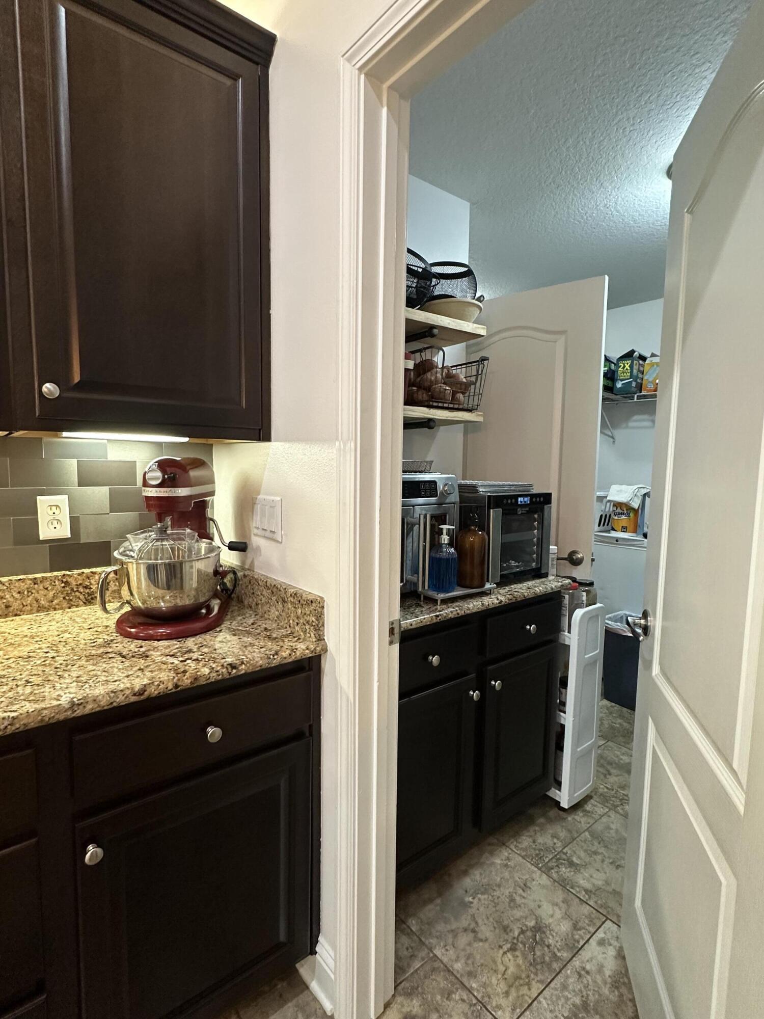 5930 Wind Trace Road Crestview, FL 32536 - Photo 25 of 68 a kitchen with stainless steel appliances granite countertop a sink stove and refrigerator