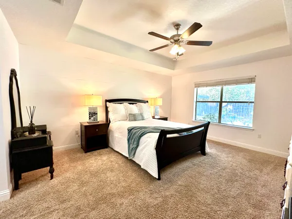 a bedroom with a bed and a ceiling fan