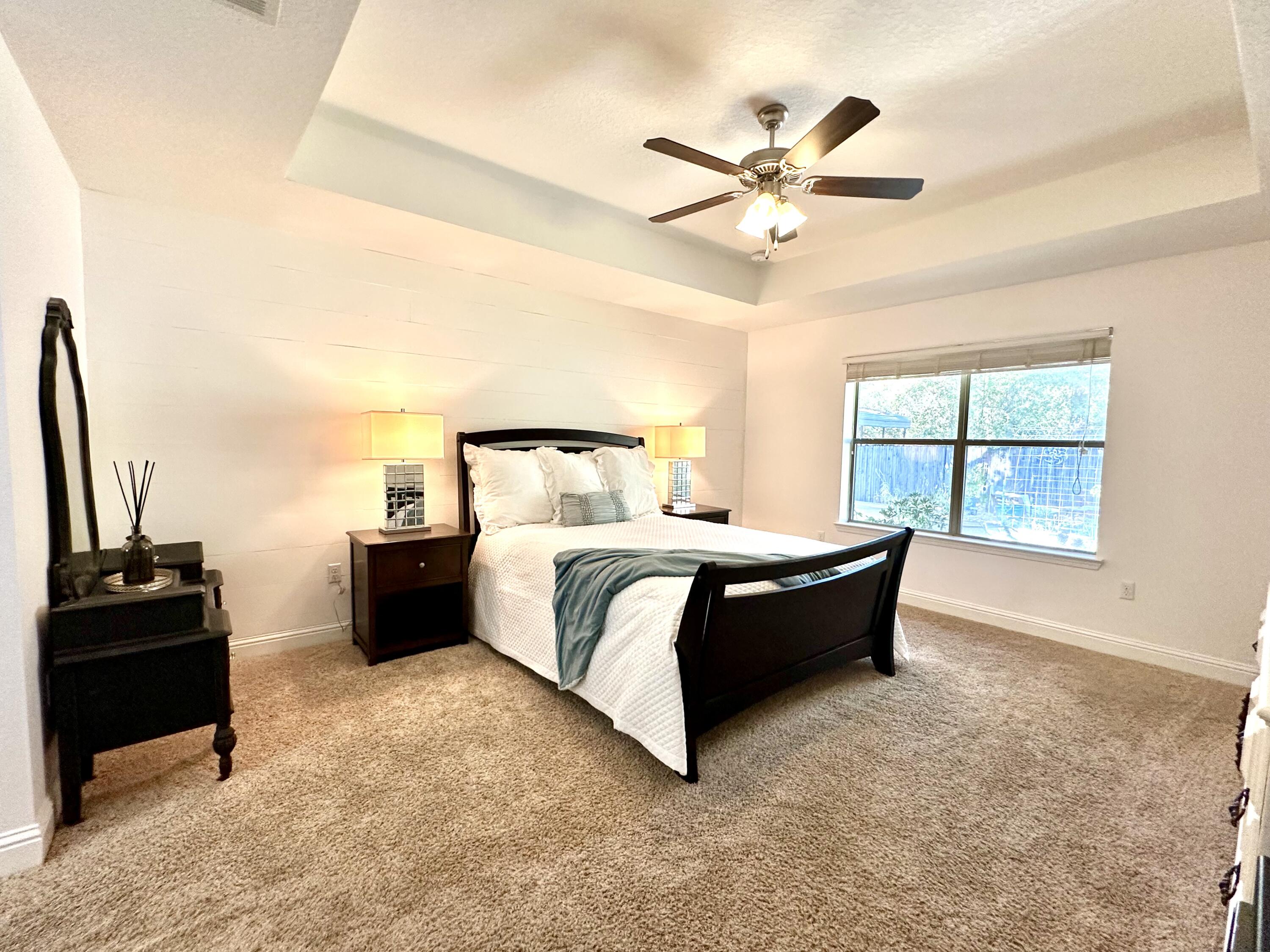 5930 Wind Trace Road Crestview, FL 32536 - Photo 29 of 68 a spacious bedroom with a bed and a window