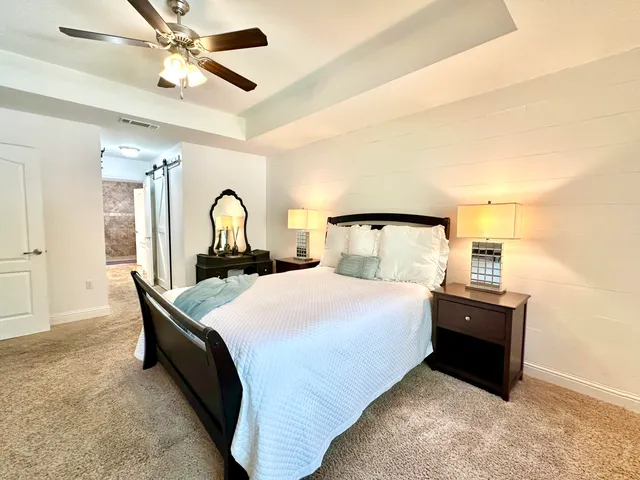 a bathroom with a granite countertop sink a toilet and a mirror