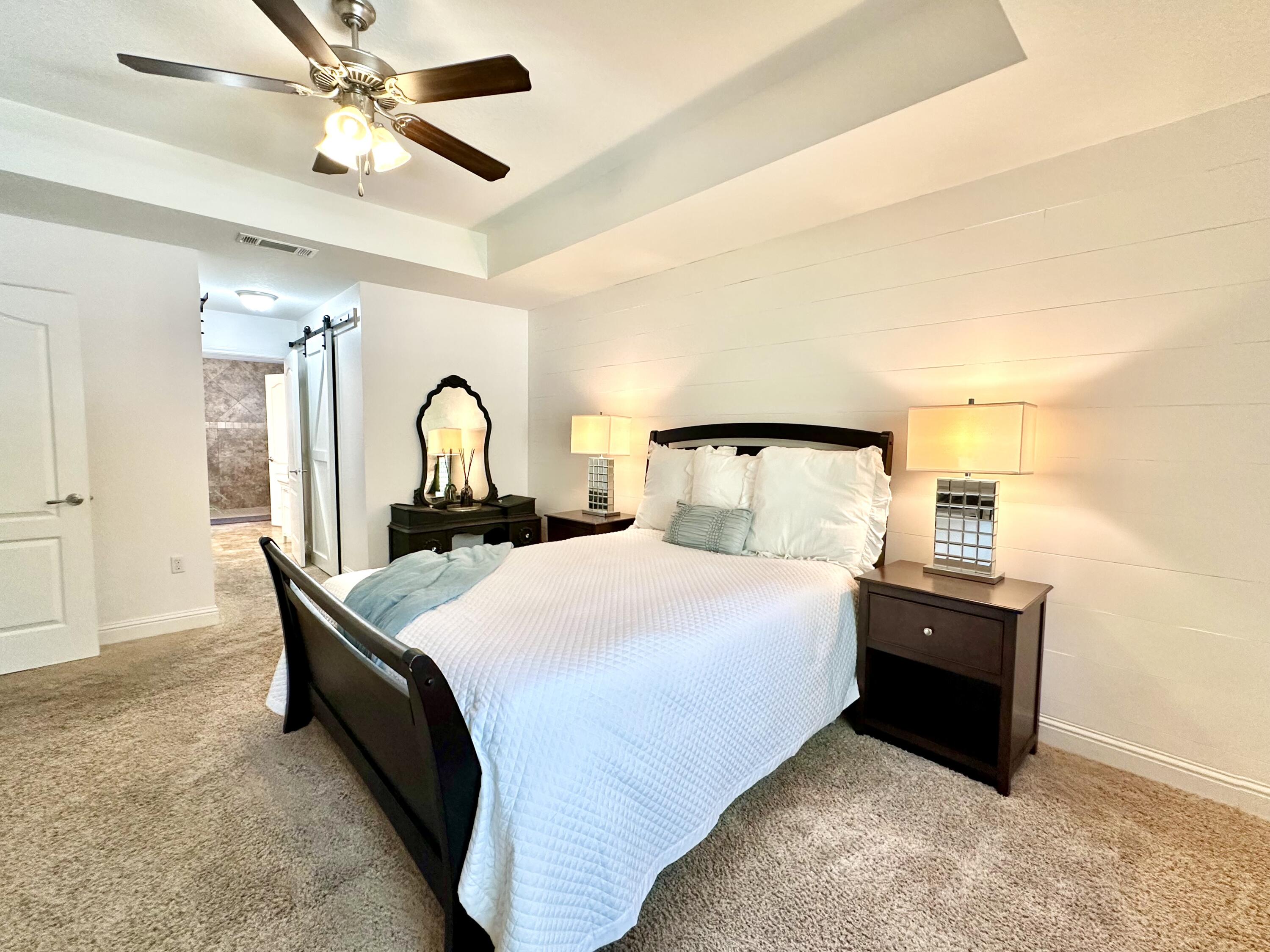 5930 Wind Trace Road Crestview, FL 32536 - Photo 30 of 68 a bedroom with a bed and dresser with mirror