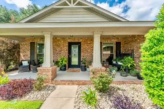 a view of a hallway with wooden floor and a living room