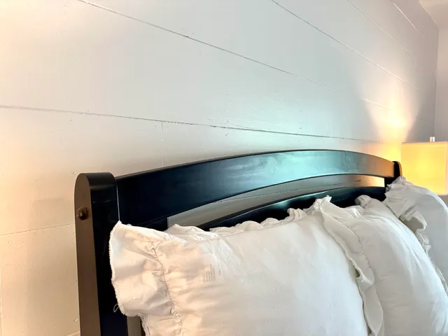 a bedroom with furniture and a flat screen tv