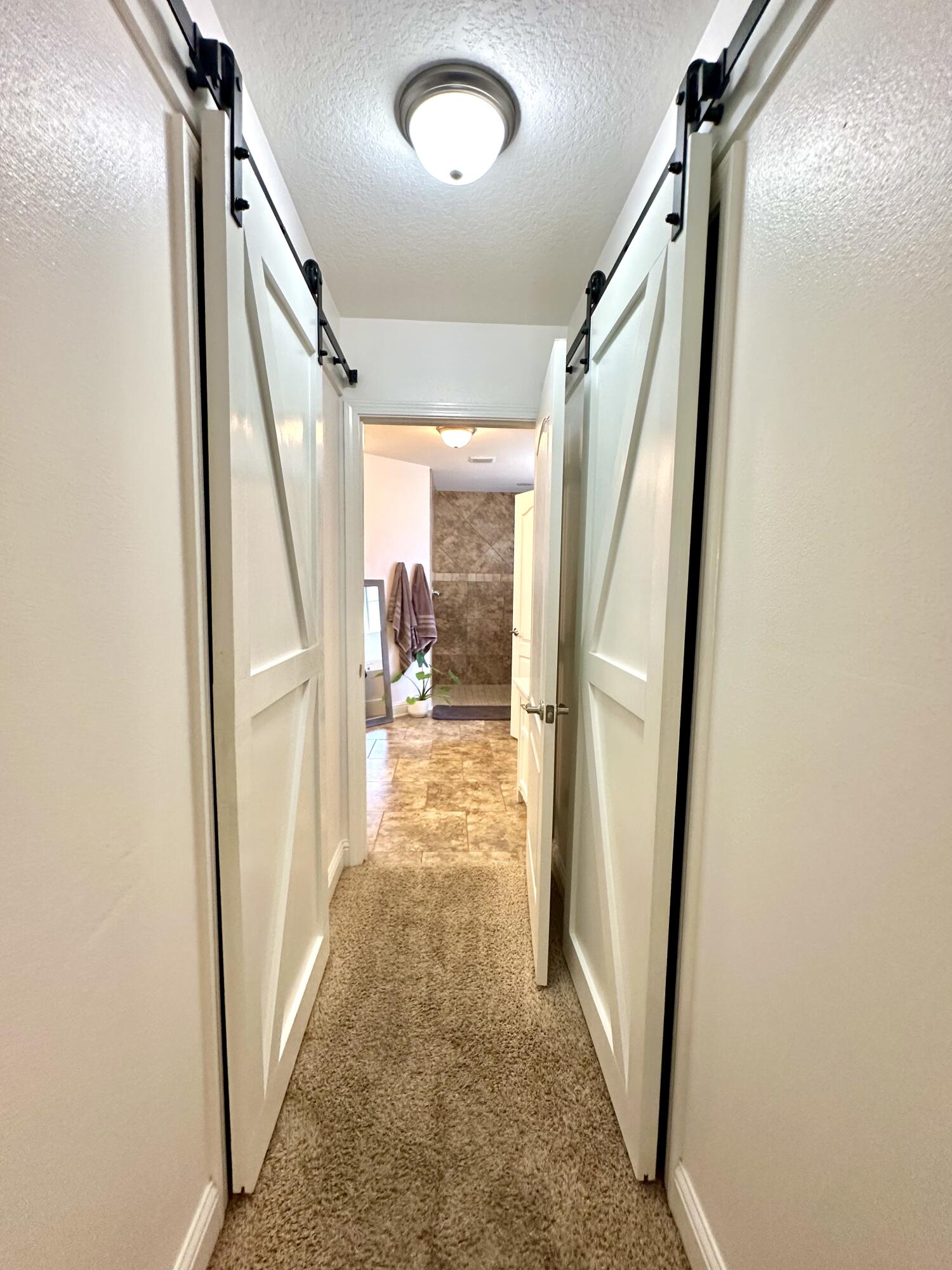5930 Wind Trace Road Crestview, FL 32536 - Photo 34 of 68 a view of a hallway with wooden floor and stairs