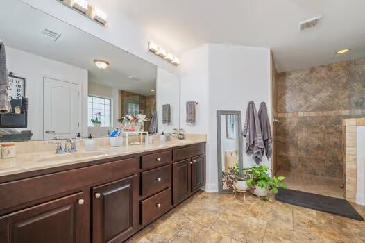 5930 Wind Trace Road Crestview, FL 32536 - Photo 35 of 68 a spacious bathroom with a granite countertop sink a mirror and a shower