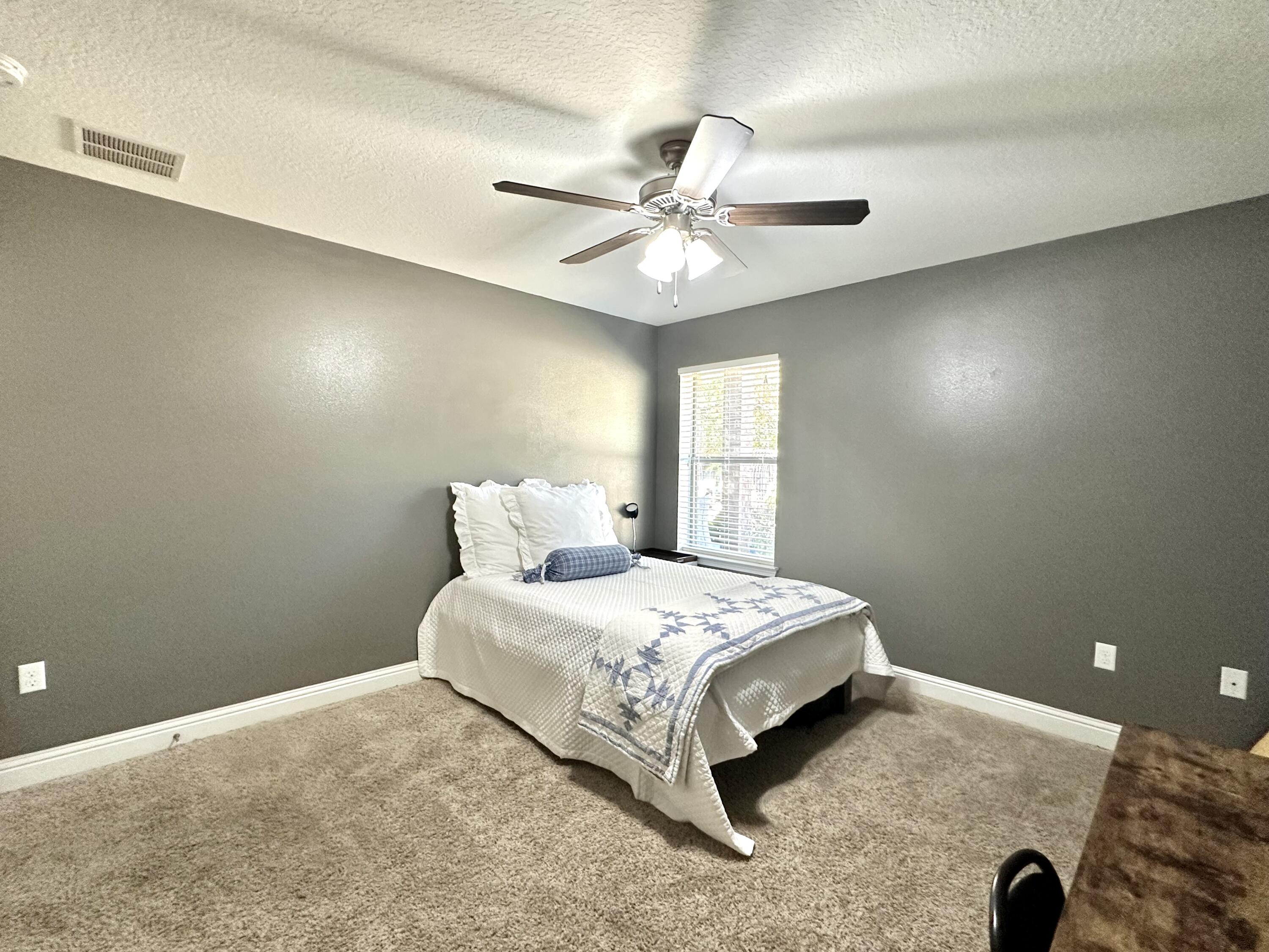 5930 Wind Trace Road Crestview, FL 32536 - Photo 42 of 68 a bedroom with a bed and a ceiling fan