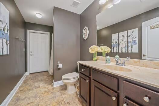 5930 Wind Trace Road Crestview, FL 32536 - Photo 43 of 68 a bathroom with a granite countertop sink a toilet and a mirror