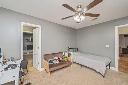 5930 Wind Trace Road Crestview, FL 32536 - Photo 48 of 68 a bedroom with a bed and a chandelier