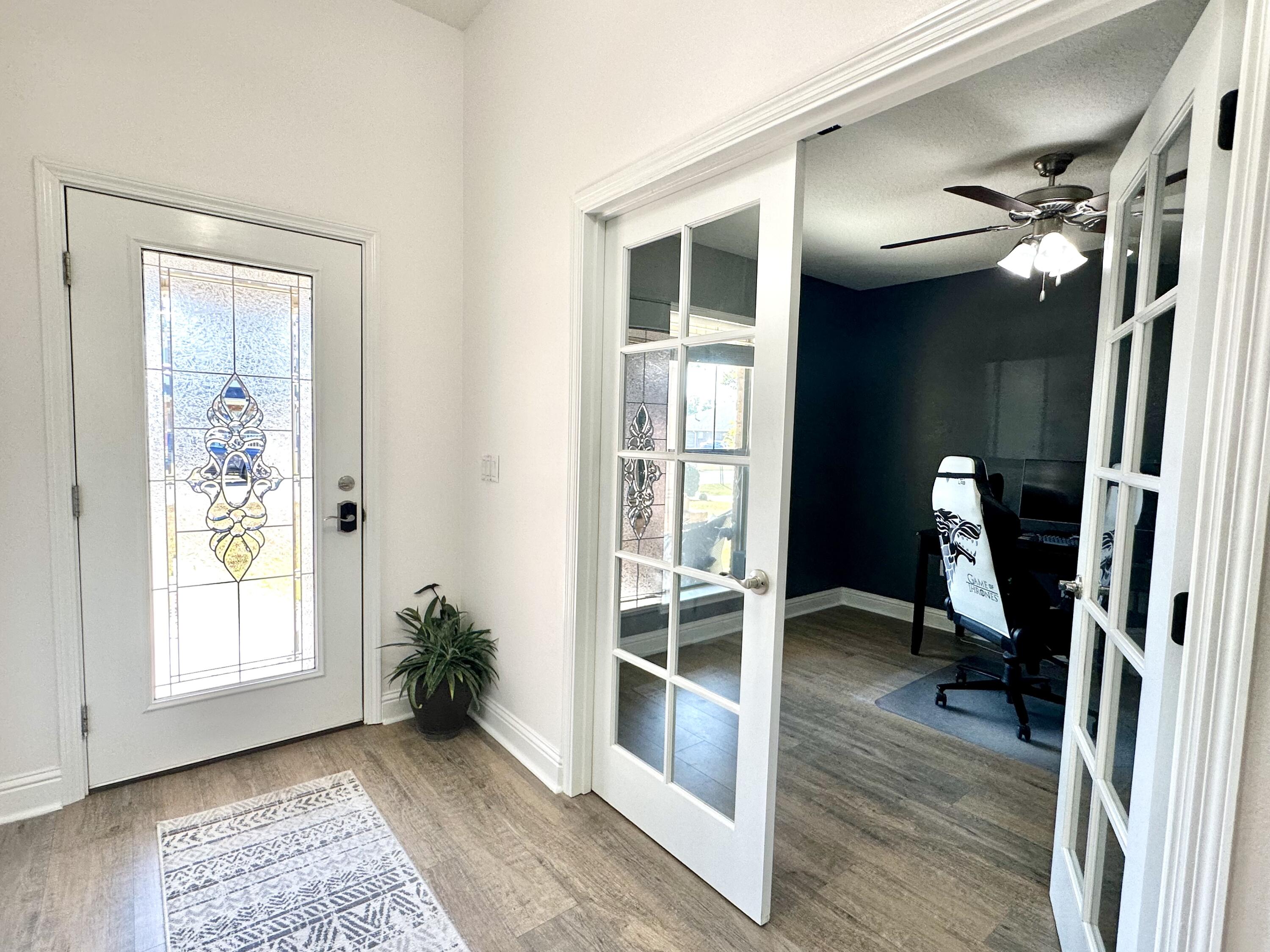 5930 Wind Trace Road Crestview, FL 32536 - Photo 5 of 68 a view of a hallway with wooden floor and windows