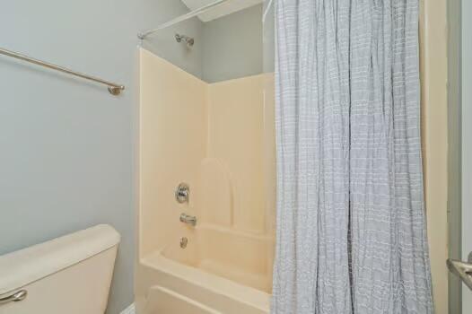 5930 Wind Trace Road Crestview, FL 32536 - Photo 52 of 68 a bathroom with a shower curtain and a toilet