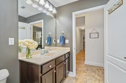 5930 Wind Trace Road Crestview, FL 32536 - Photo 53 of 68 a bathroom with a sink vanity and a mirror