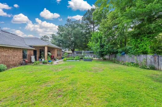 5930 Wind Trace Road Crestview, FL 32536 - Photo 54 of 68 a front view of a house with garden