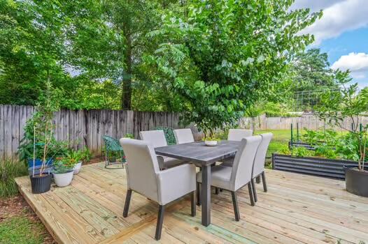 5930 Wind Trace Road Crestview, FL 32536 - Photo 55 of 68 a view of a table and chairs in back yard of the house