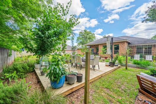 5930 Wind Trace Road Crestview, FL 32536 - Photo 58 of 68 a view of a house with backyard sitting area and garden