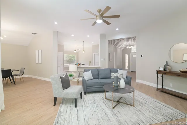 a living room with furniture and a wooden floor