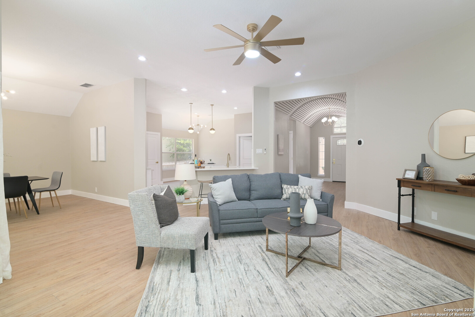 a living room with furniture and a wooden floor